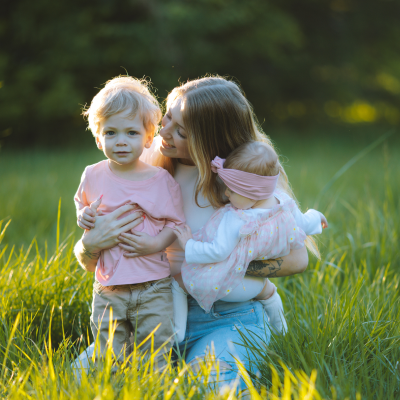 mom with two kids in the fields