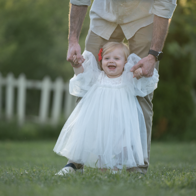 little child walking on grass