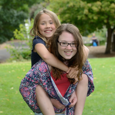 mom carrying a happy child on back